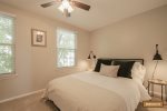 Guest room with queen size bed and ceiling fan